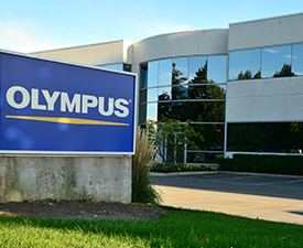 Olympus sign in front of an office building