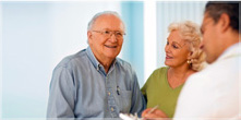 Senior couple in a doctor's office consulting with a clinician