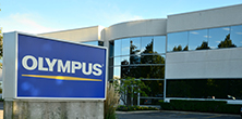 Olympus sign in front of office building