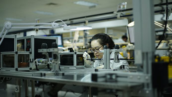 Female technician analyzing an endoscope in a laboratory