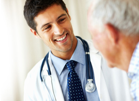 Male doctor consulting with senior male patient