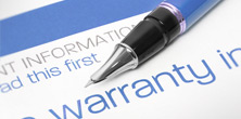 A pen resting on top of a warranty document