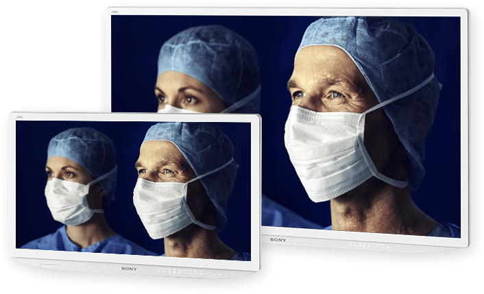 Two Sony monitors both displaying the same image of two surgeons in scrubs with the smaller monitor in front